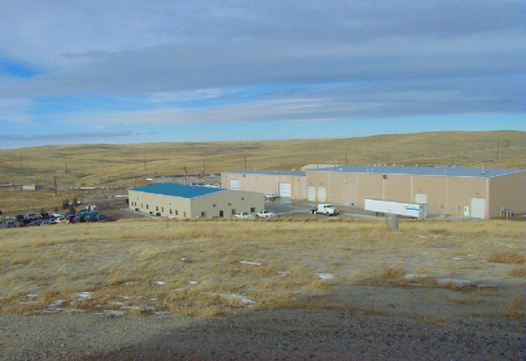 Central processing plant buildings at a uranium in-situ recovery site on open grassland
